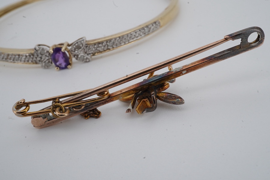 An amethyst and diamond bangle, inner circumference 17.5cm, mounted in gold, gross weight 7 grams; and an Edwardian bar brooch designed as an insect, set with a circular-cut aquamarine and seed pearls, mounted in gold, l